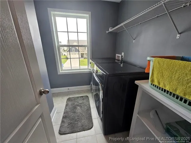 a bathroom with a granite countertop sink a toilet and a window