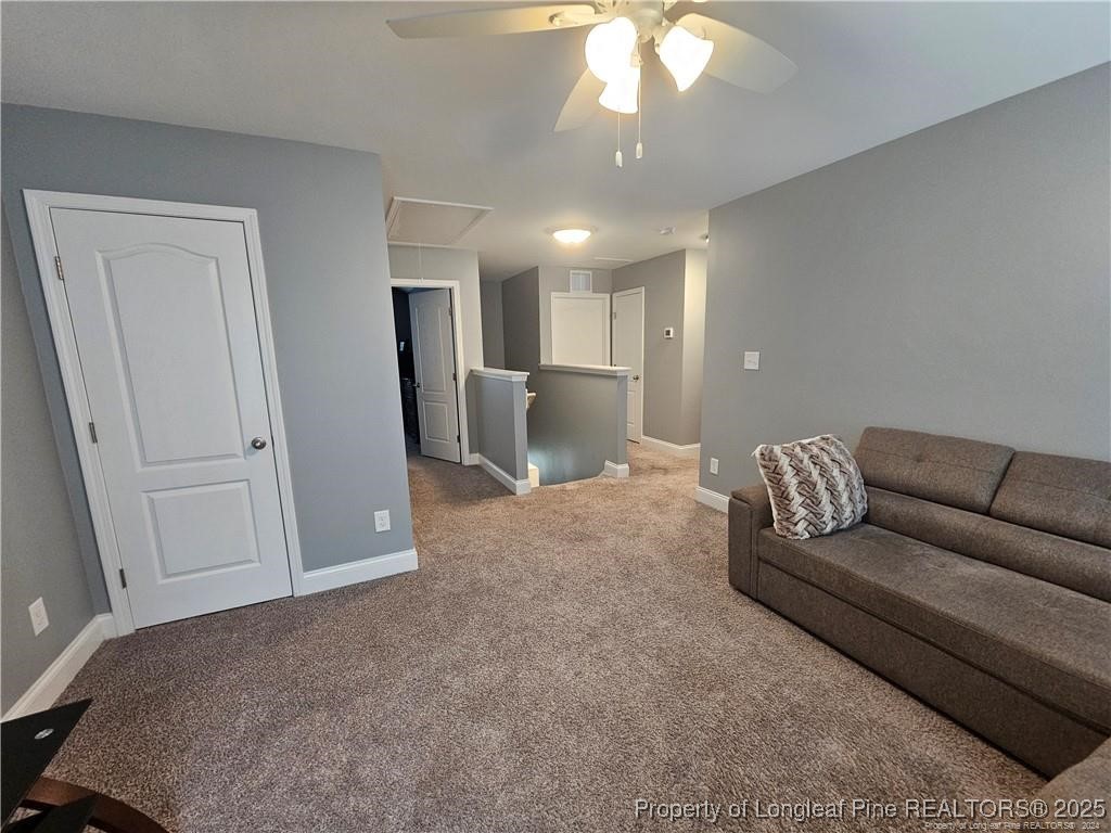 181 Pendleton Street Raeford, NC 28376 - Photo 17 of 19 a living room with furniture and a chandelier