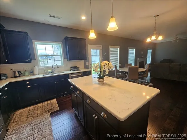 a kitchen with a sink appliances and cabinets