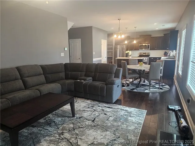 a living room with furniture and kitchen view