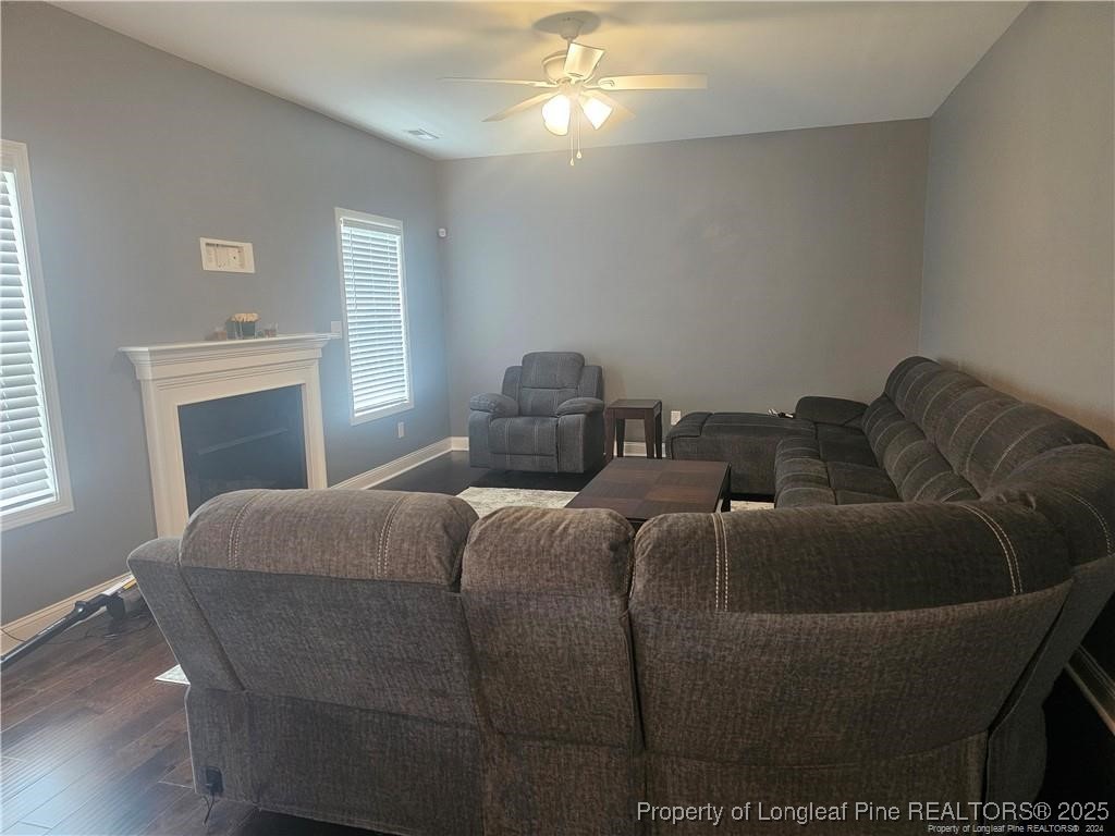 181 Pendleton Street Raeford, NC 28376 - Photo 9 of 19 a bed sitting in a bedroom next to a window and a chandelier