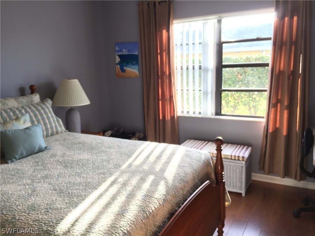 26485 Rampart Boulevard, Unit E3 Punta Gorda, FL 33983 - Photo 12 of 22 a bedroom with a bed and a window