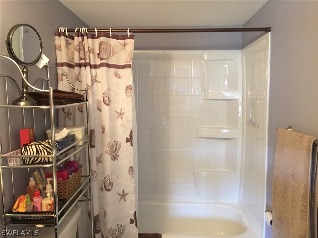 26485 Rampart Boulevard, Unit E3 Punta Gorda, FL 33983 - Photo 14 of 22 a bathroom with a bathtub and a shower