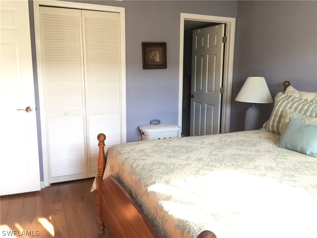 26485 Rampart Boulevard, Unit E3 Punta Gorda, FL 33983 - Photo 15 of 22 a bedroom with a bed and a potted plant