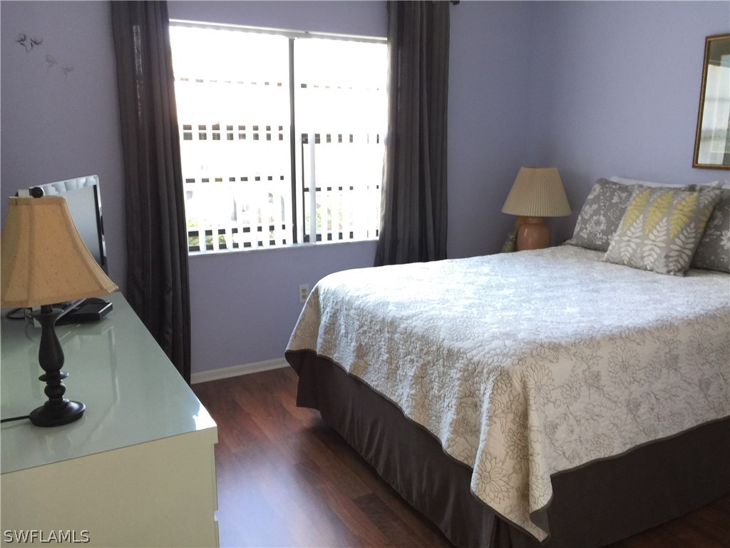 26485 Rampart Boulevard, Unit E3 Punta Gorda, FL 33983 - Photo 16 of 22 a bedroom with a bed and window