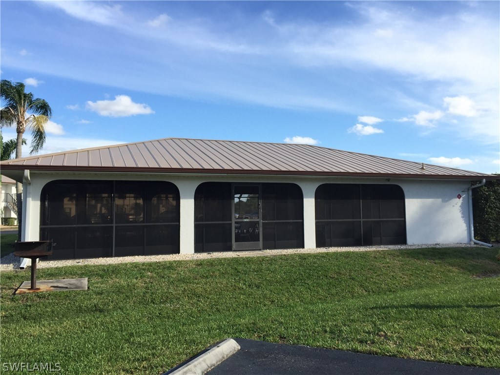 26485 Rampart Boulevard, Unit E3 Punta Gorda, FL 33983 - Photo 19 of 22 a view of a house with a yard