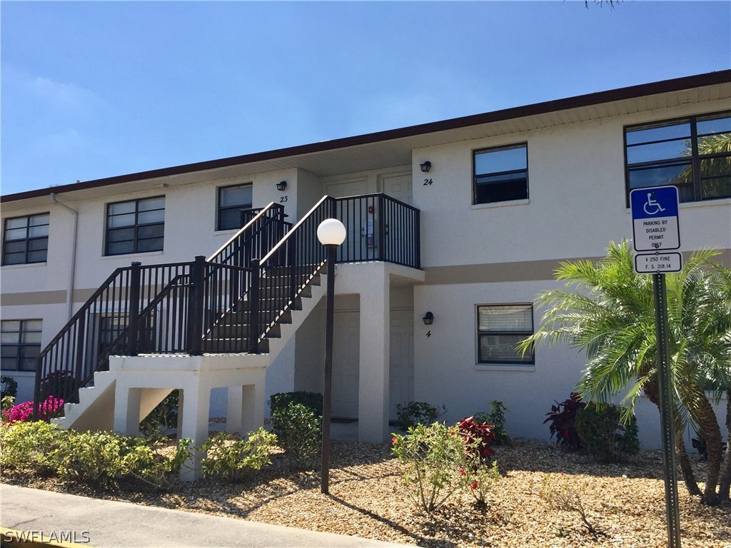 26485 Rampart Boulevard, Unit E3 Punta Gorda, FL 33983 - Photo 2 of 22 a front view of house along with road and trees