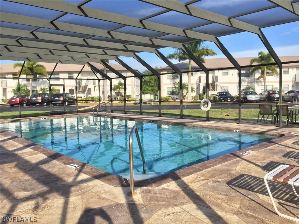 26485 Rampart Boulevard, Unit E3 Punta Gorda, FL 33983 - Photo 3 of 22 a view of a swimming pool with a patio