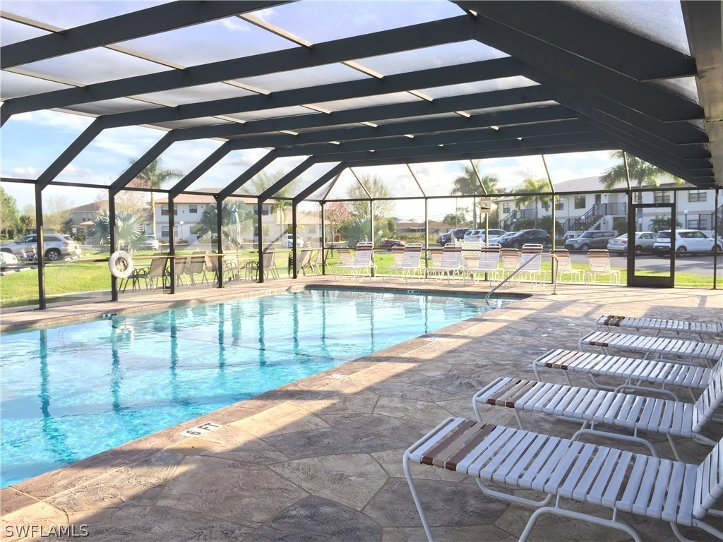 26485 Rampart Boulevard, Unit E3 Punta Gorda, FL 33983 - Photo 4 of 22 a view of a swimming pool with a porch