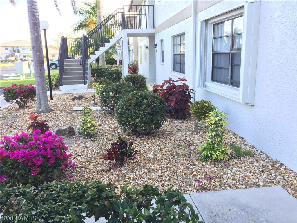 26485 Rampart Boulevard, Unit E3 Punta Gorda, FL 33983 - Photo 5 of 22 a front view of a house with a yard