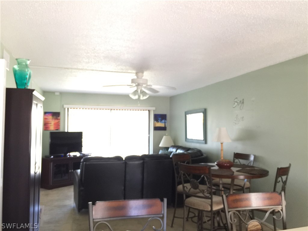 26485 Rampart Boulevard, Unit E3 Punta Gorda, FL 33983 - Photo 8 of 22 a living room with furniture a window and a flat screen tv