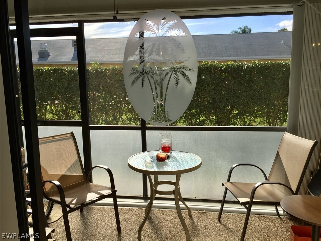 26485 Rampart Boulevard, Unit E3 Punta Gorda, FL 33983 - Photo 9 of 22 a living room with couches and a table with garden view