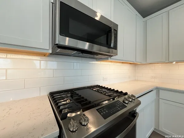 a stove top oven sitting inside of a kitchen