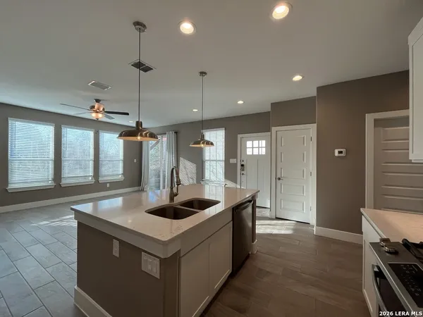 a kitchen with stainless steel appliances granite countertop a sink and a refrigerator