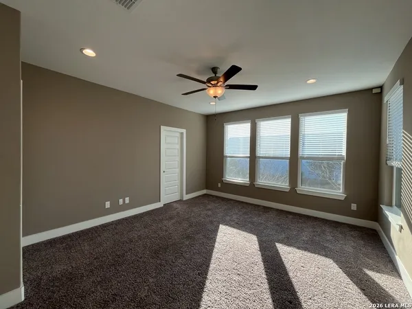 a view of room with a ceiling fan and window