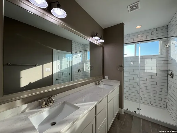 a bathroom with a double vanity sink mirror and double