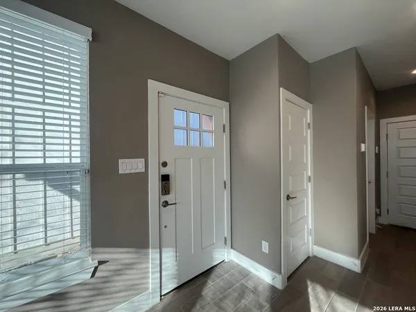 a view of a bathroom with wooden floor and windows