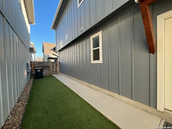 a backyard of a house with garden and barbeque oven