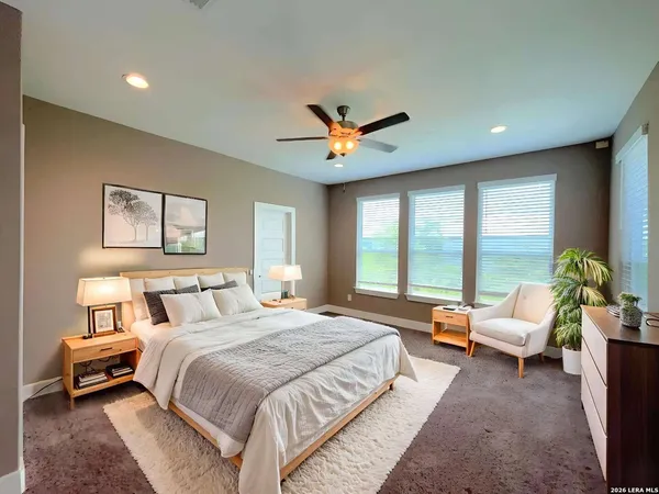 a spacious bedroom with a bed and a couch