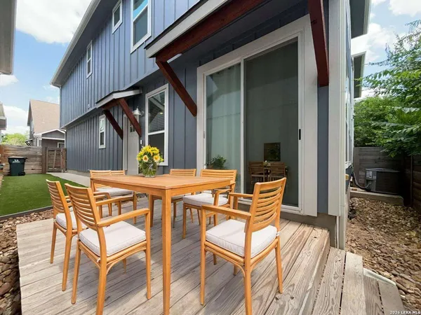 a view of house with backyard and outdoor seating