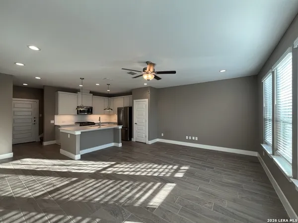 a kitchen with a refrigerator and a stove top oven