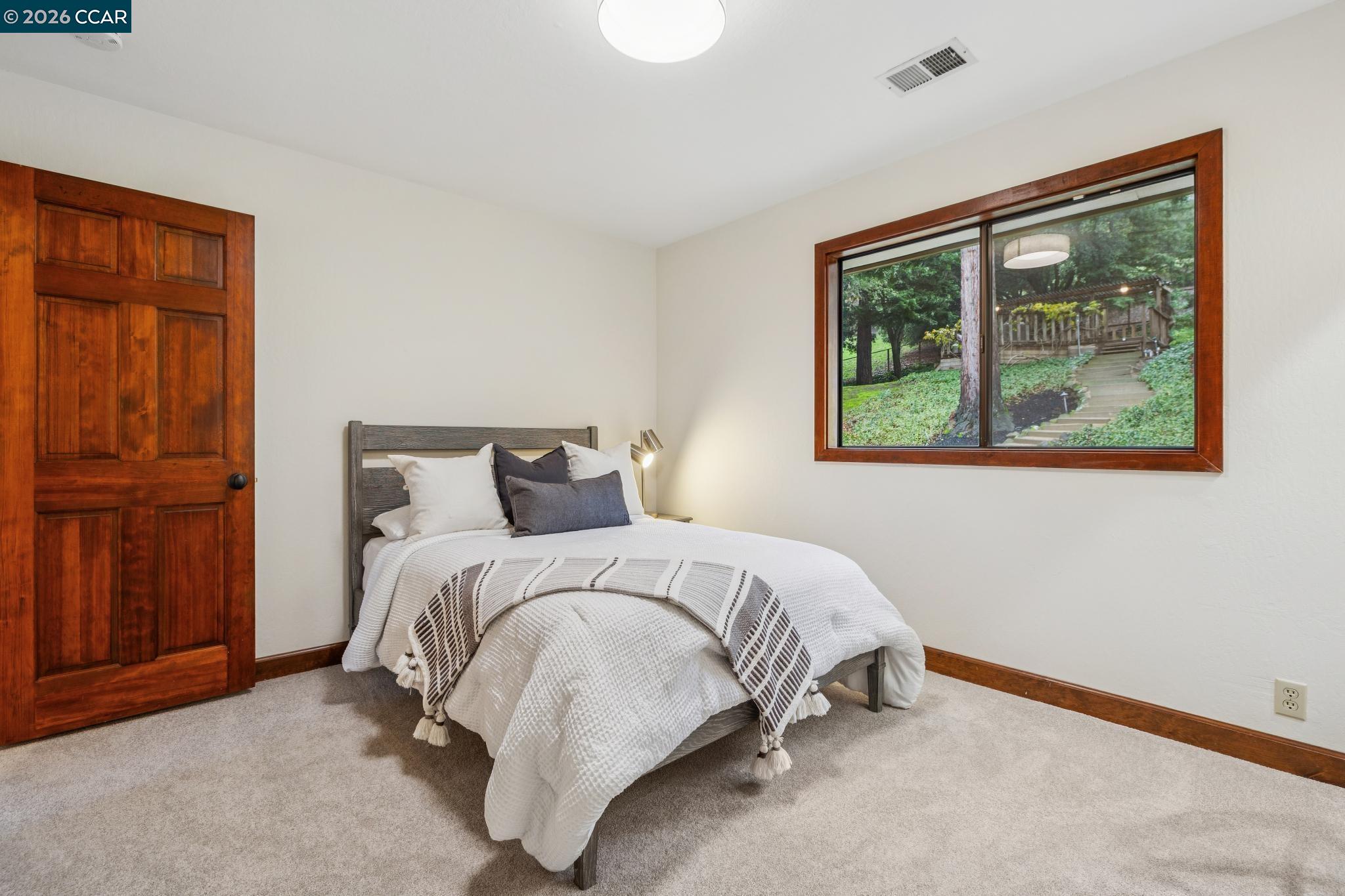 1324 A Martino Road Lafayette, CA 94549 - Photo 35 of 55 a bed sitting in a bedroom next to a window