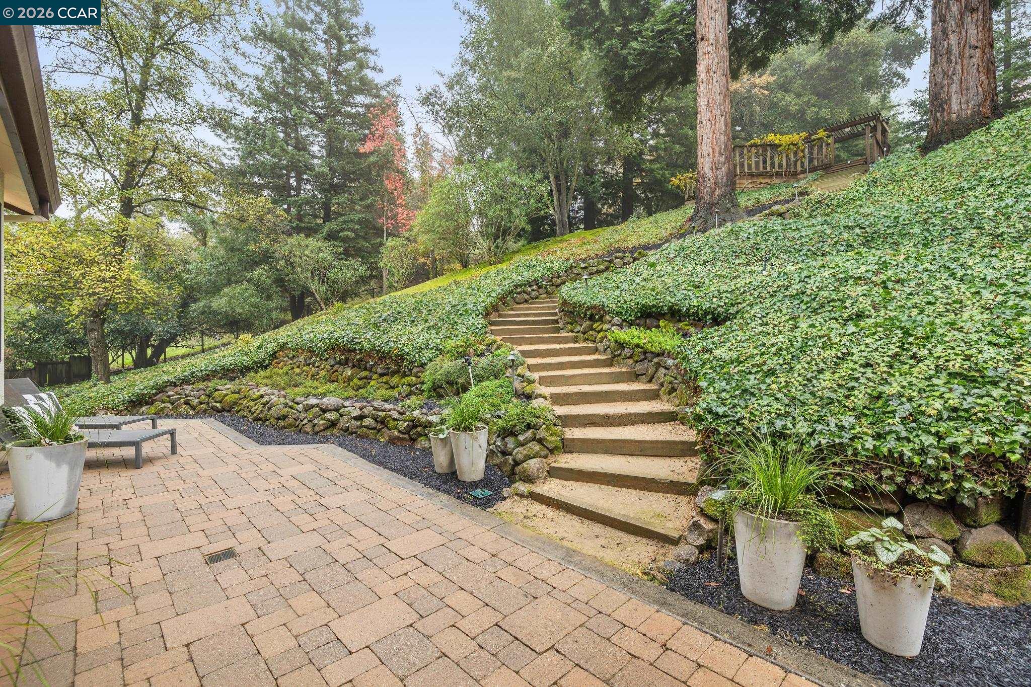 1324 A Martino Road Lafayette, CA 94549 - Photo 45 of 55 a view of a backyard with chair and potted plants