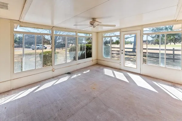 a view of an empty room with windows