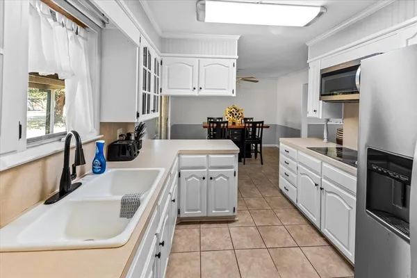 a kitchen with a sink stove and cabinets