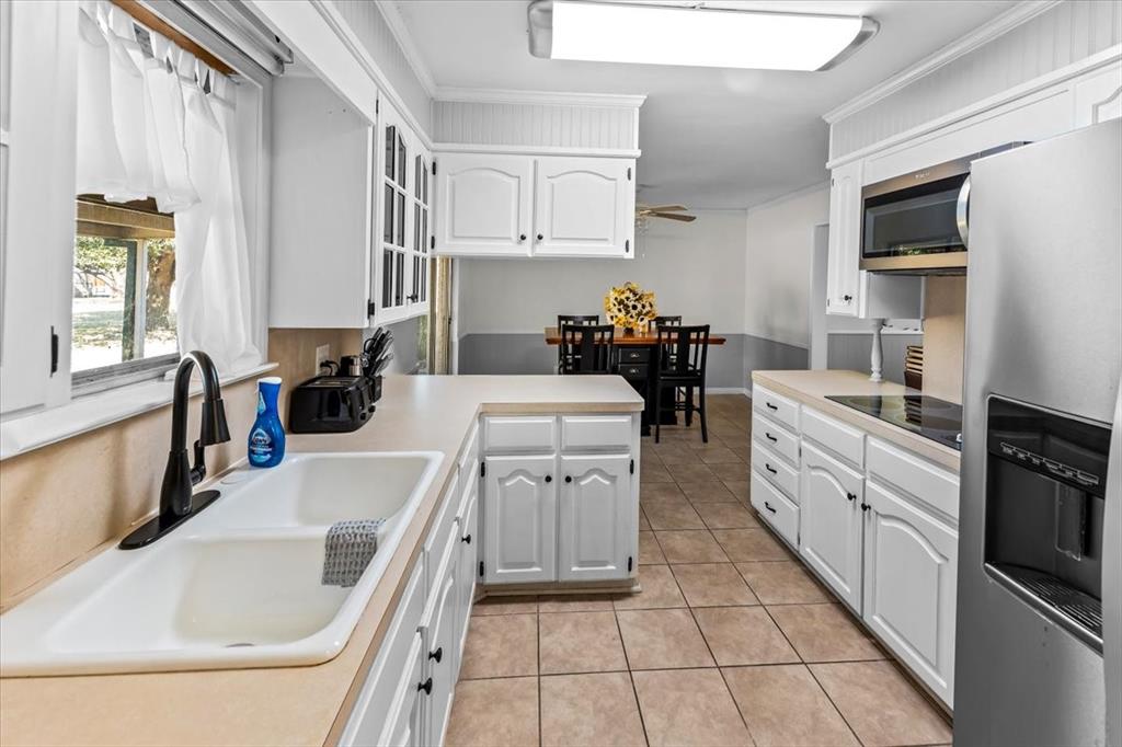 9313 Tree Lake Drive Waco, TX 76708 - Photo 13 of 35 a kitchen with a sink stove and cabinets