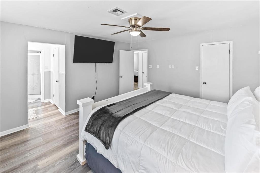 9313 Tree Lake Drive Waco, TX 76708 - Photo 14 of 35 a bedroom with a bed tv and a chandelier