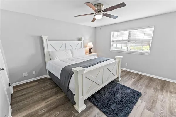 a bedroom with a bed rug and window