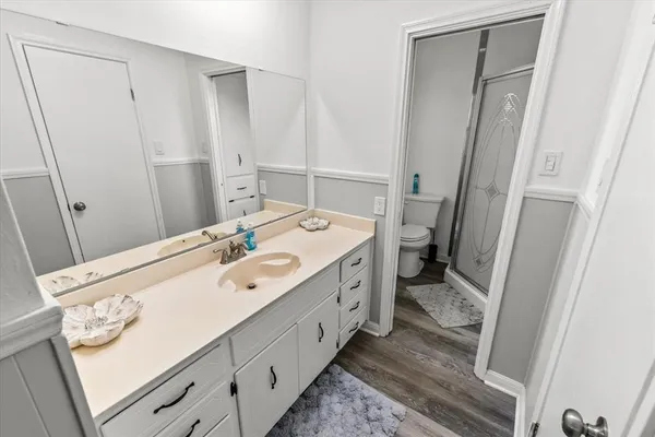 a spacious bathroom with a double vanity sink and a mirror