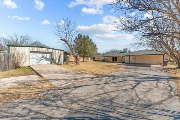 a view of a yard with large trees