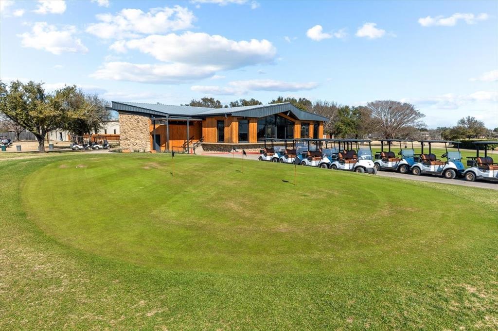 9313 Tree Lake Drive Waco, TX 76708 - Photo 33 of 35 a front view of a house with a garden and lake view