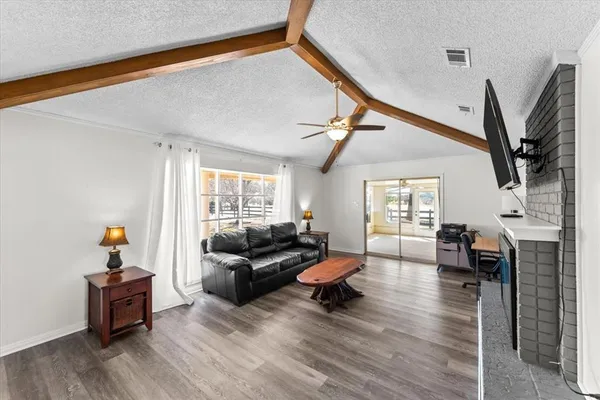 a living room with furniture and a wooden floor