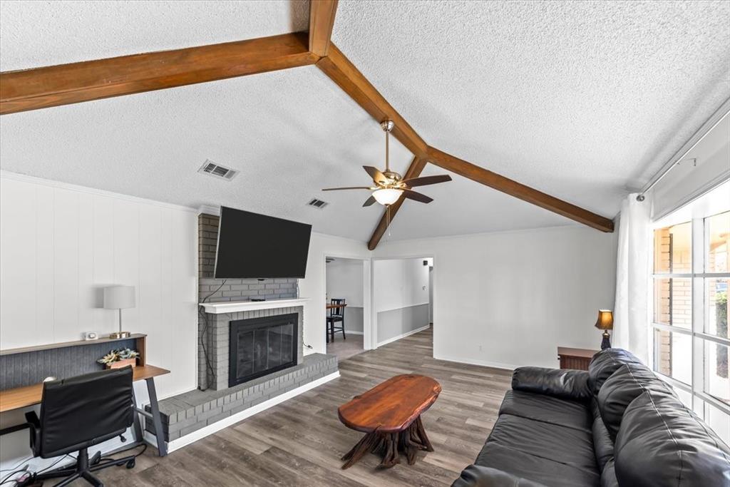 9313 Tree Lake Drive Waco, TX 76708 - Photo 8 of 35 a living room with furniture a flat screen tv and a fireplace