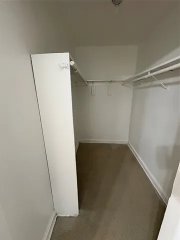 a kitchen with cabinets and wooden floor