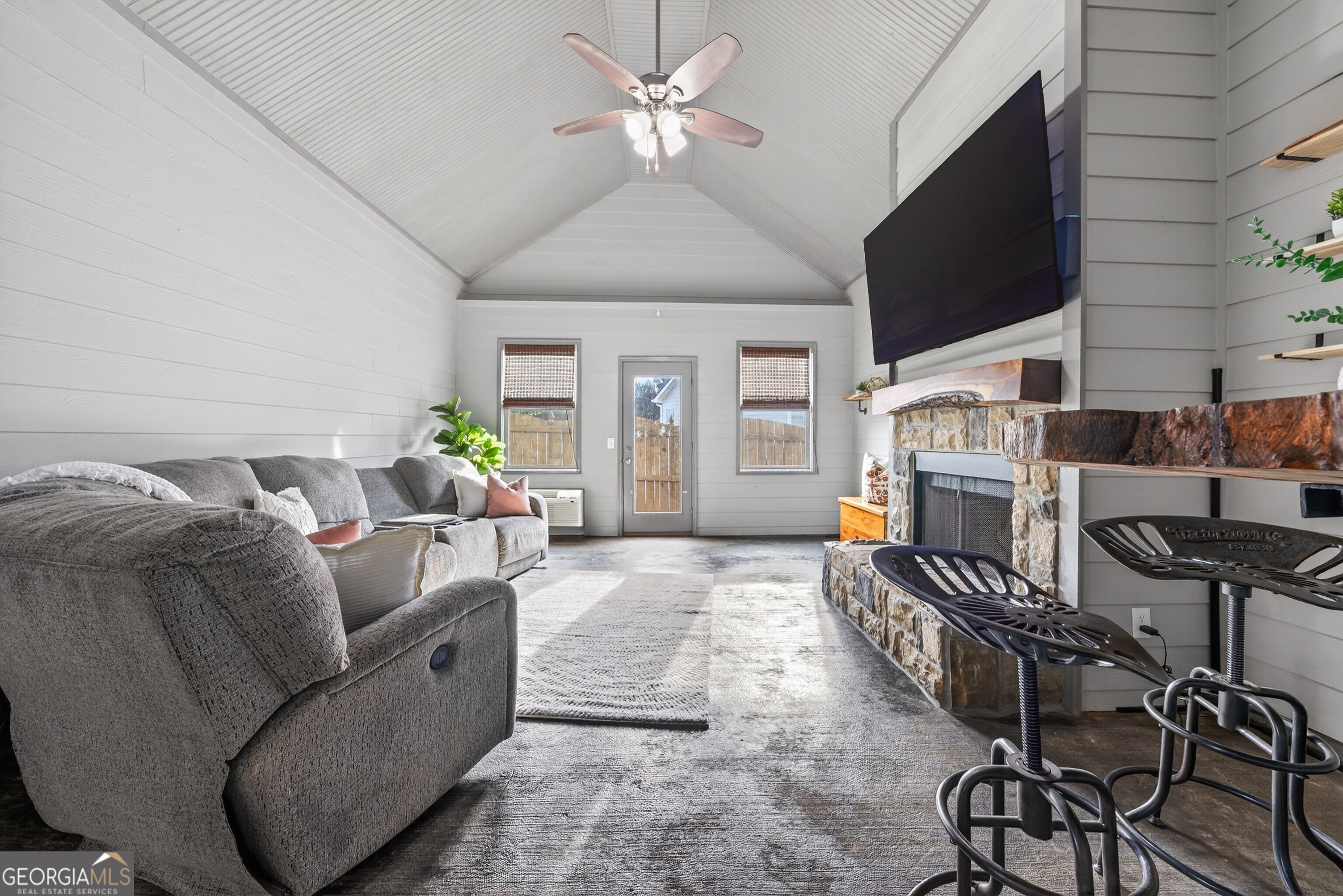 4772 Fairways Lane Jefferson, GA 30549 - Photo 11 of 56 a living room with furniture a flat screen tv and a fireplace