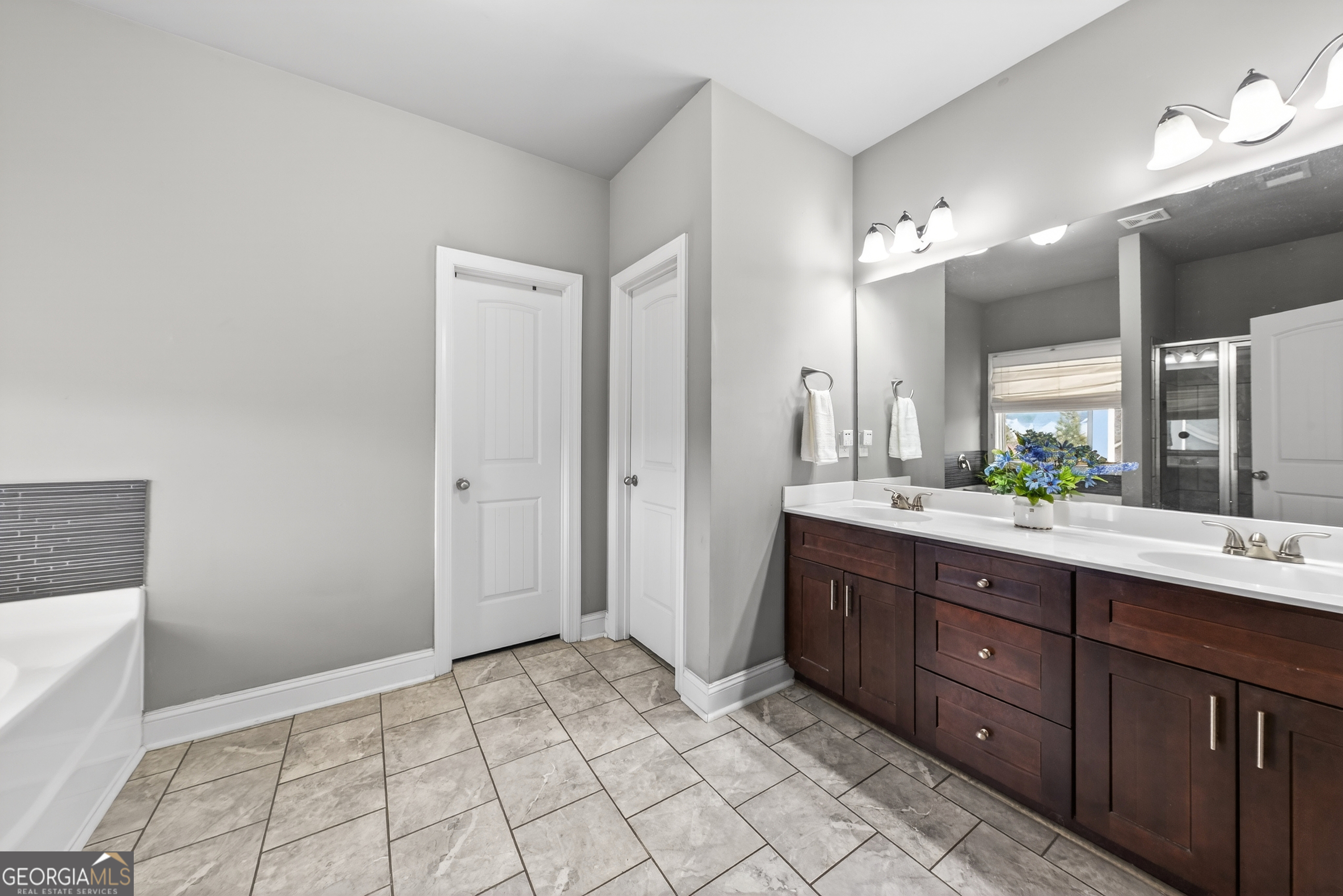 4772 Fairways Lane Jefferson, GA 30549 - Photo 15 of 56 a spacious bathroom with a double vanity sink mirror and