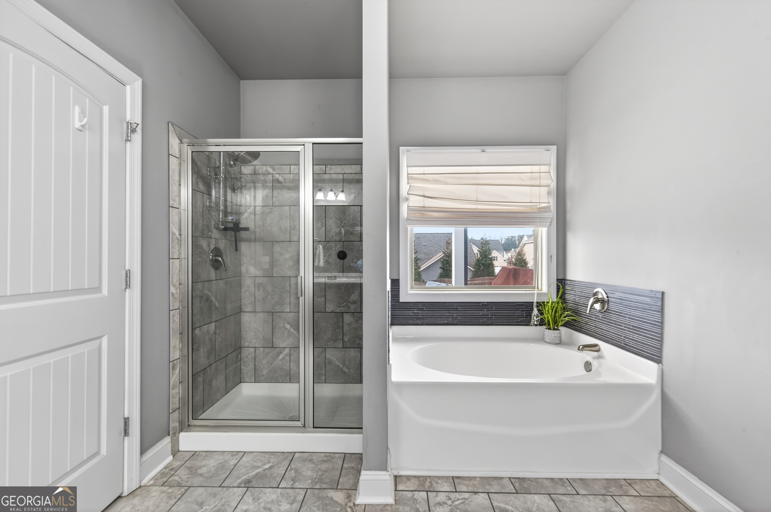 4772 Fairways Lane Jefferson, GA 30549 - Photo 16 of 56 a bathroom with a bathtub and a shower