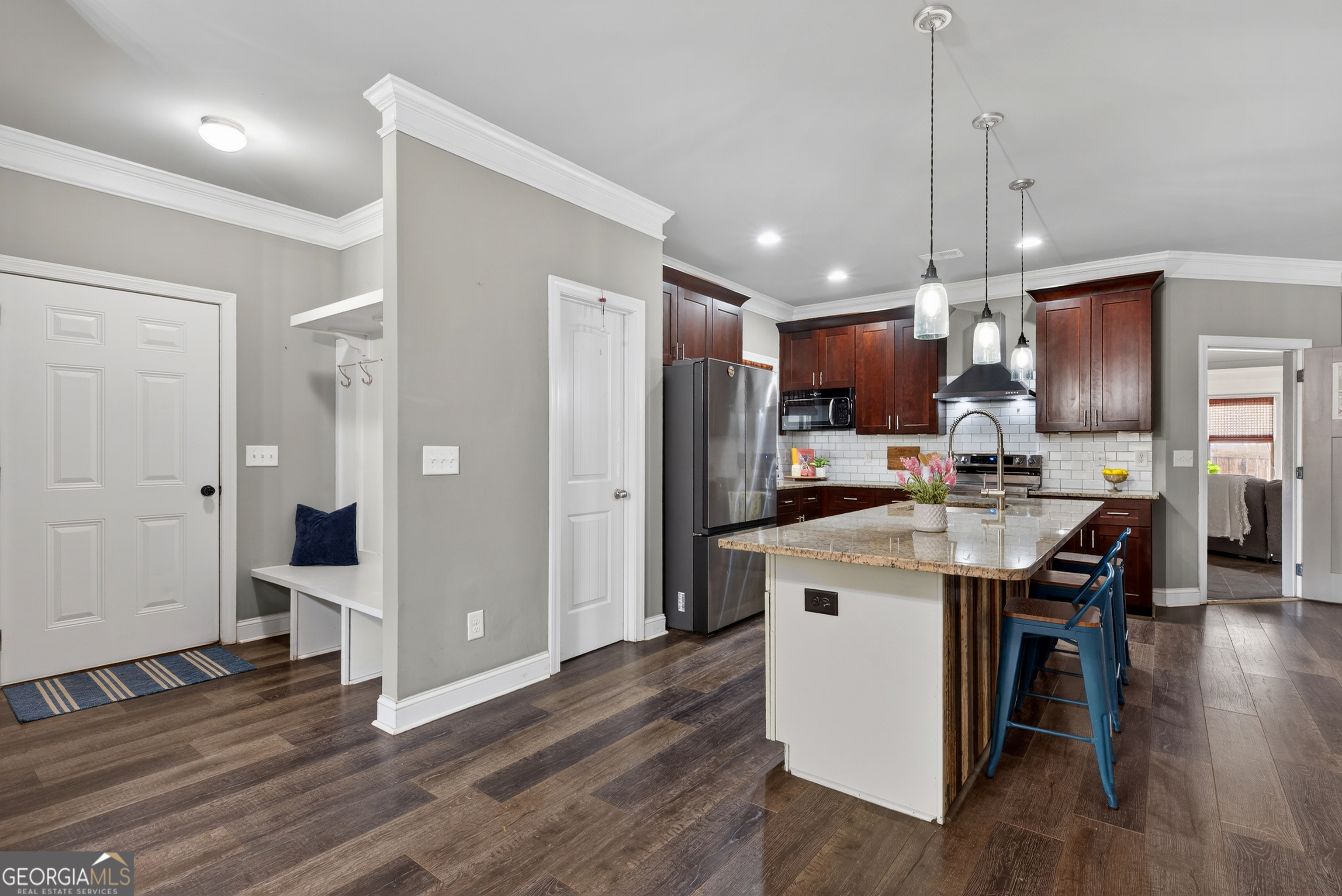 4772 Fairways Lane Jefferson, GA 30549 - Photo 31 of 56 a kitchen with stainless steel appliances kitchen island granite countertop wooden floors and white cabinets