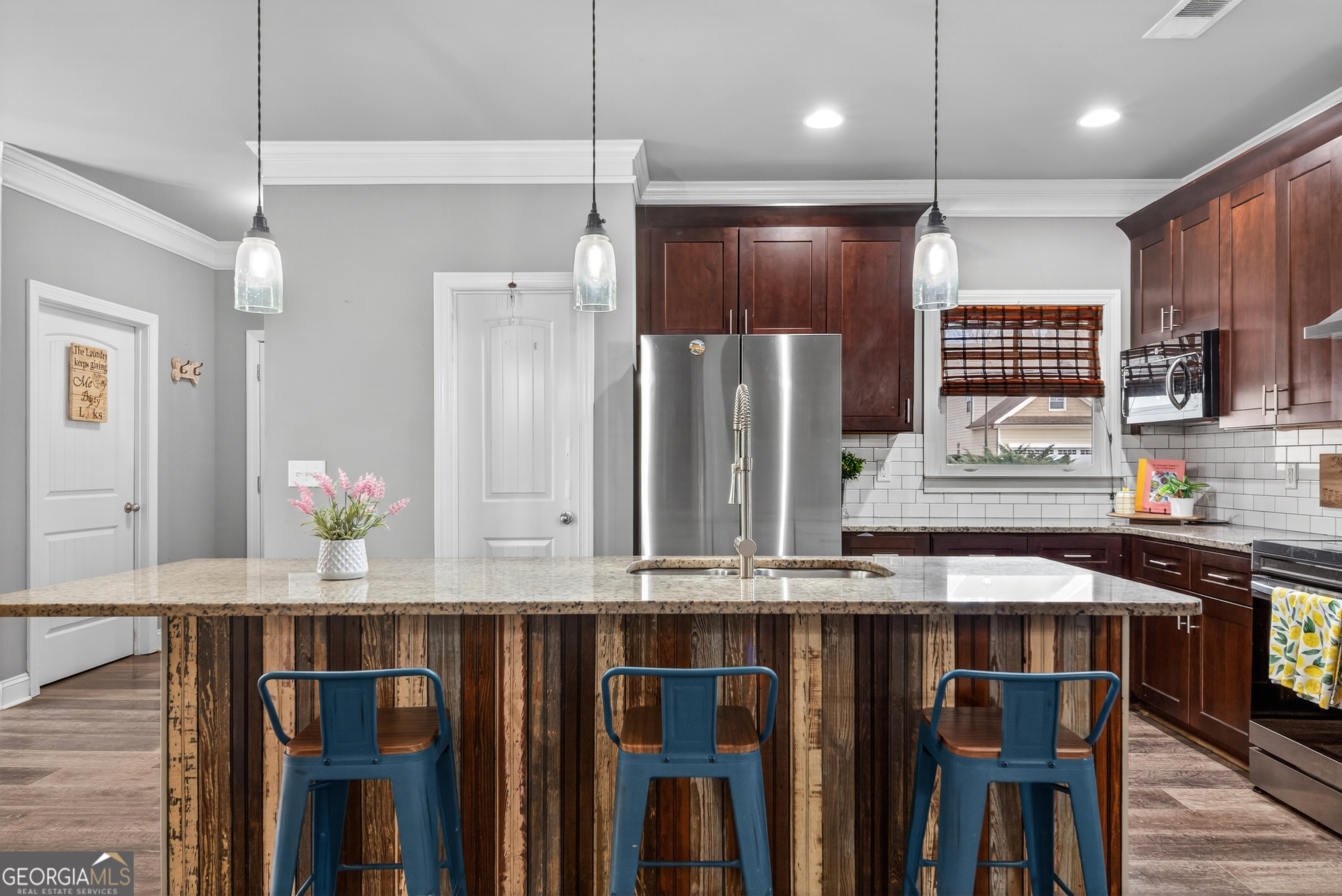 4772 Fairways Lane Jefferson, GA 30549 - Photo 32 of 56 a kitchen with kitchen island granite countertop a sink appliances and cabinets