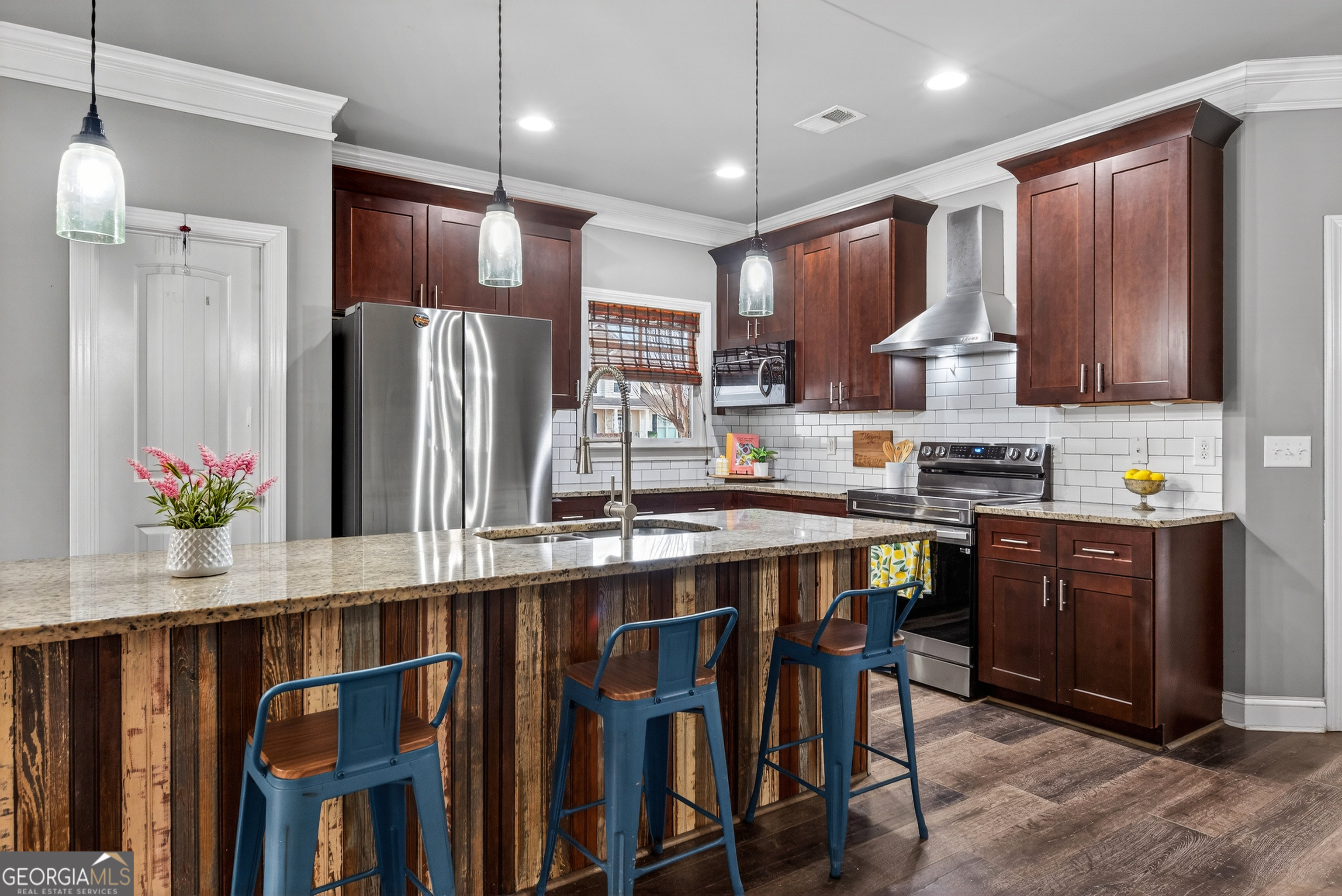 4772 Fairways Lane Jefferson, GA 30549 - Photo 7 of 56 a kitchen with stainless steel appliances granite countertop a refrigerator a sink dishwasher a stove and a dining table with wooden floor
