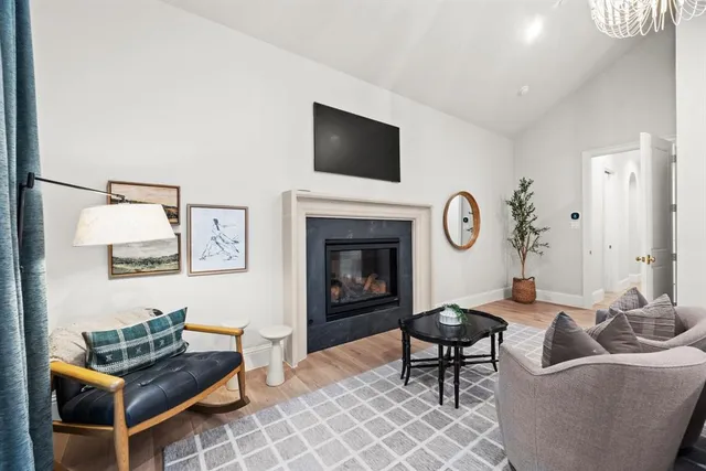 a living room with furniture a rug and a fireplace