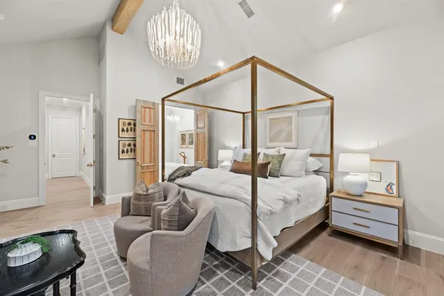 a bedroom with a bed couch and window