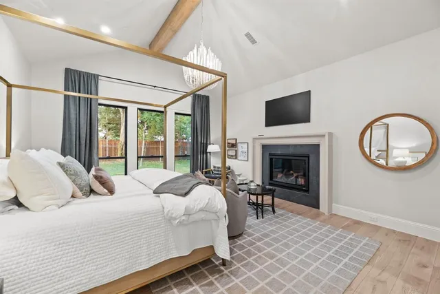 a bedroom with a large bed and a fireplace