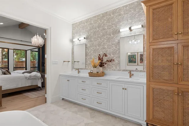 a spacious bathroom with a double vanity sink a mirror a bathtub and