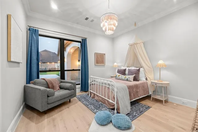 a bedroom with furniture and a large window