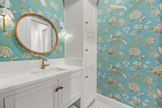 a bathroom with a sink and mirror